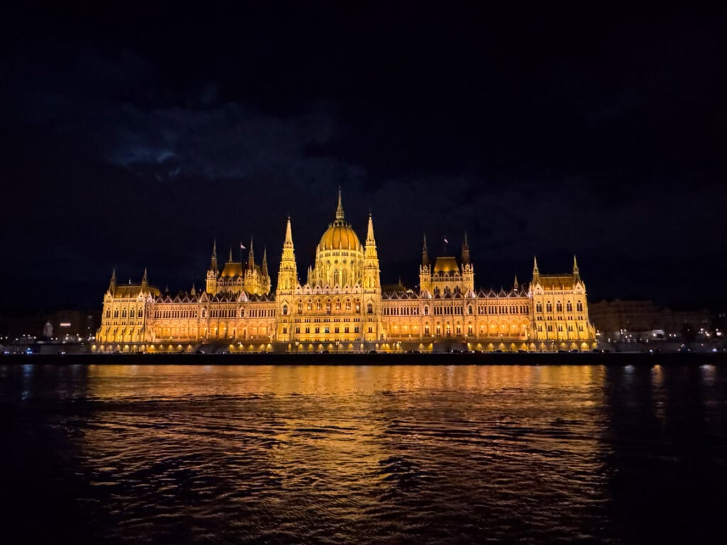 The Budapest Parliament building all lit up at night (view from a river cruise)