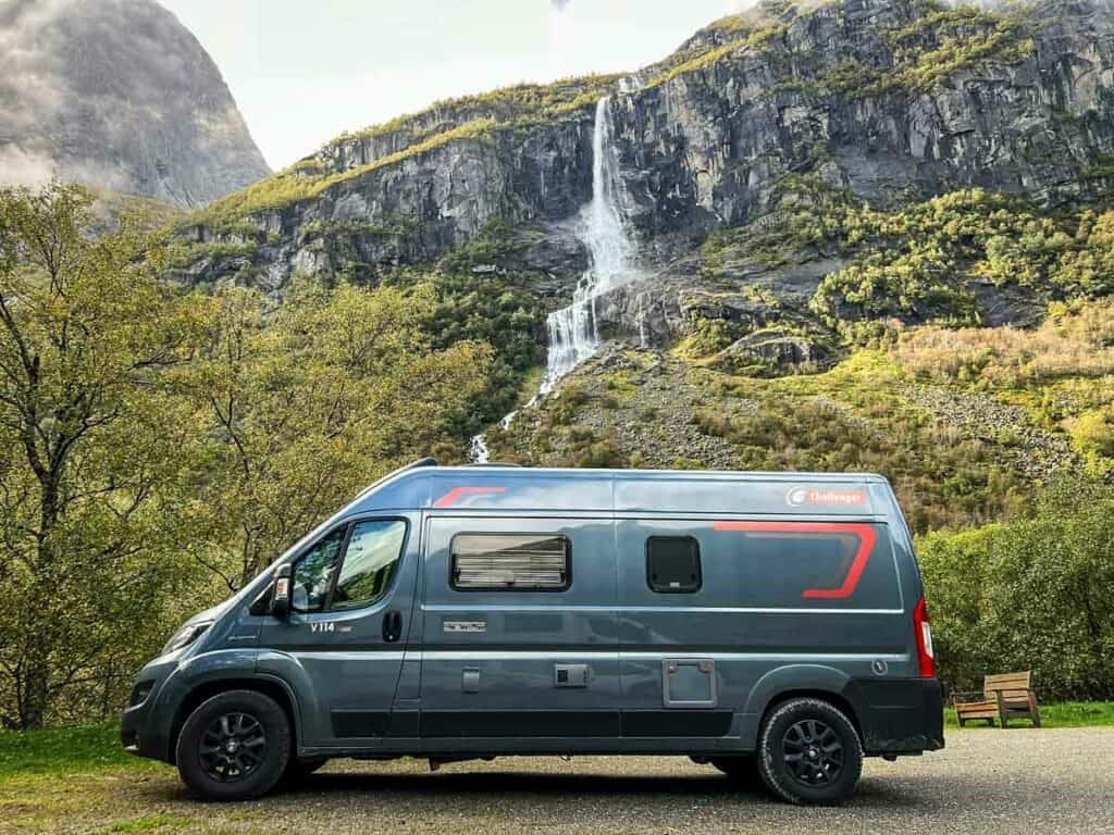 Norway campervan rental parked in front of a waterfall