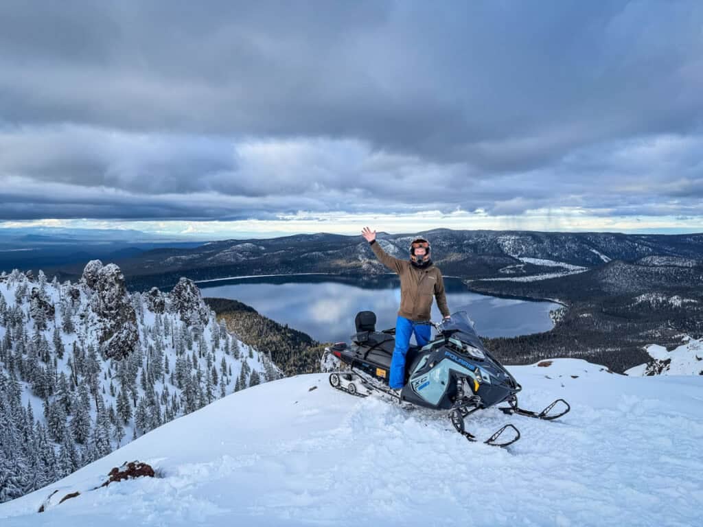 Ben snowmobile at Paulina Peak near Bend, Oregon lake background