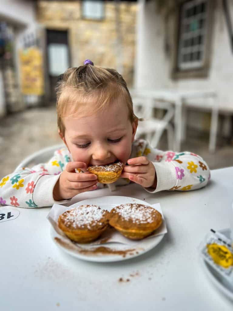 Juniper eating pastel de nata in Portugal